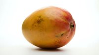 Ripe mango with golden-yellow and red skin isolated on white background, ready for food and beverage design, packaging, and culinary content use.
