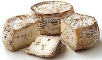 Artisanal cheese wheels with white mold rind, one cut to show creamy interior texture on white background, fresh dairy product for gourmet food photography.