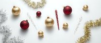 Festive Christmas ornaments and tinsel garland scattered on white background. Holiday decorations in gold and red colors for seasonal celebration design.