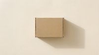 Closed kraft cardboard box on neutral beige background, overhead view, ready for packaging design, shipping, e-commerce, and product mockup applications.