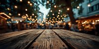 Rustic wooden table with blurred evening street cafe and bokeh lights in background, creating cozy atmosphere for dining.