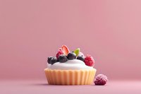 Fresh berry tartlet with whipped cream topped with strawberries, blueberries and raspberries on pink background, minimalist dessert photography.