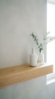 Minimalist bathroom shelf with white pump bottle and clear glass vase holding fresh eucalyptus branches, natural wood shelf, bright window light, clean aesthetic for spa and wellness design.