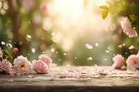 Soft pink roses scattered on wooden surface with dreamy bokeh light and floating petals creating romantic spring atmosphere for wedding designs.