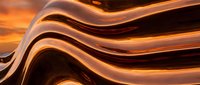Smooth flowing liquid waves in warm golden and bronze tones create an abstract background suitable for modern design, wallpapers, and creative projects.