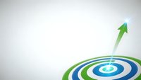 Green arrow hitting center of blue and green target bullseye on white background representing success, achievement and goal reaching in business strategy.
