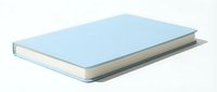 Closed hardcover book with light blue cover and white pages isolated on white background, ready for design mockups and educational materials.