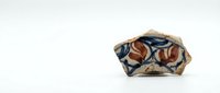 Isolated mineral specimen featuring copper oxide crystals with rich brown and blue metallic tones on natural rock matrix, suitable for educational materials and design projects.