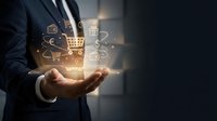 Businessman holding glowing digital commerce icons in cupped hands showing online shopping cart, payment and delivery symbols for ecommerce technology concepts.