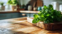 Fresh mint leaves on wooden cutting board in rustic kitchen, natural ingredient for cooking and cocktails.