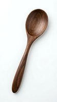 Handcrafted wooden spoon isolated on white background for kitchen utensils, cooking tools, and culinary design projects.