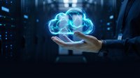 Businessman holding glowing cloud computing hologram in palm representing digital transformation and data storage technology solutions for modern business.