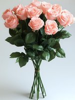Bouquet of fresh pink roses with green foliage arranged in clear glass vase against white background. Perfect for floral design, wedding, celebration, and greeting card projects.