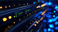 Network fiber optic cables with glowing blue and orange lights in dark server room, close up view showing data transmission and connectivity in modern datacenter.
