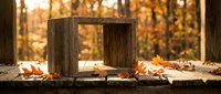 Rustic wooden frame on weathered surface with scattered autumn leaves and blurred fall forest background, suitable for seasonal design projects and nature-themed compositions.