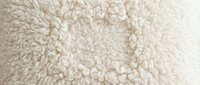 Soft beige wool carpet texture with dense pile, suitable for interior design, flooring backgrounds, and home decor projects.