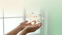 Hands cupped together with glowing peace symbols and hearts floating above, representing harmony, love, unity and spiritual wellness concepts.