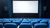Empty modern cinema theater with blue seats and white screen, illuminated by soft ambient lighting in dark auditorium. Rows of comfortable chairs face blank projection surface.