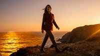 Woman jogging along coastal cliffs at sunset, athletic wear, outdoor fitness and wellness lifestyle photography for health and exercise content.