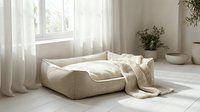 Cozy beige pet bed with knit blanket in a bright minimalist room with sheer curtains and natural light, serene home interior.