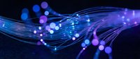 Abstract blue and purple flowing waves with glowing particles and light effects on dark background for digital technology and futuristic design projects.