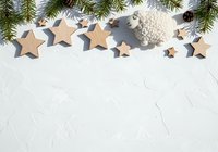 Wooden stars and silver ornaments with evergreen branches on white textured background, ideal for holiday greeting cards, seasonal marketing, and festive design projects.