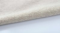 Beige ribbed knit fabric texture with soft folds on white background, suitable for fashion, textile, and apparel design projects.