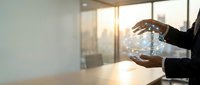 Business professional holding glowing digital globe in modern office with city skyline view representing global connectivity and innovation.