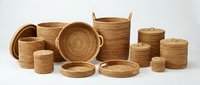 Collection of handwoven natural wicker baskets and containers in various sizes for home organization and storage solutions on white background.