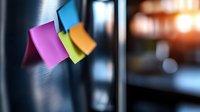 Colorful sticky notes on dark blurred background with soft focus and bokeh effect create modern office atmosphere for business communication and reminders.