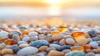 Smooth pebbles and stones in warm sunset light on beach, mix of white, orange and blue colors creating tranquil natural composition for wellness and spa designs.