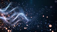 Glowing particles form dynamic waves against dark background with shimmering bokeh lights and flowing energy streams in blue and orange colors. For tech backgrounds.