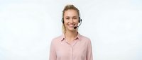 Smiling young Caucasian woman customer service representative wearing headset and pink shirt on white background isolated for business design.