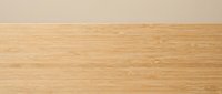 Natural bamboo wood texture background with horizontal grain pattern and warm beige wall for interior design and flooring applications.