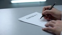 Business professional signing contract document with pen at office desk for legal agreement and partnership deal.