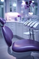 Modern dental office interior with purple patient chair and professional equipment in clean clinical environment for healthcare marketing materials.