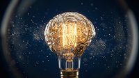 Glowing vintage light bulb with warm filament against starry night sky background symbolizing creativity innovation and bright ideas for business concepts.