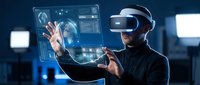 Young professional man wearing VR headset interacting with holographic interface displaying data analytics and digital elements in modern tech environment.