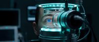 Futuristic cyborg head with glowing cyan circuitry and mechanical components integrated into human face, representing artificial intelligence and technology fusion.