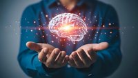 Businessman holding glowing brain with neural network connections representing artificial intelligence, machine learning and cognitive technology innovation.