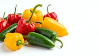Fresh colorful hot chili peppers mix including red yellow and green varieties isolated on white background for cooking spice ingredient design.
