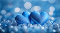 Two blue satin hearts nestled together on sparkling crystal surface with soft bokeh lights in background, romantic Valentine concept for love and relationships.