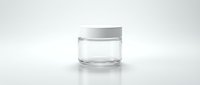Empty clear glass cosmetic jar with white lid on white background, isolated mockup for cream, skincare, or beauty product packaging design.