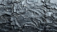 Detailed gray rock surface with natural cracks and weathered texture for backgrounds, geology studies, and natural material designs.