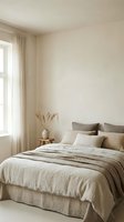 Serene bedroom interior with neutral tones, natural linen bedding, minimalist decor, and soft window light for home design and lifestyle content.