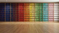 Colorful rainbow bookshelf wall with organized books in spectrum colors from blue to white, modern library interior with wooden floor for education concepts.