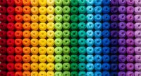 Colorful rainbow gradient pattern of spherical beads arranged in rows transitioning from red to purple. Perfect for backgrounds, textures, and design projects.