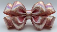 Shimmery pink holographic ribbon bow with iridescent finish isolated on gray background for gift wrapping and festive decoration projects.