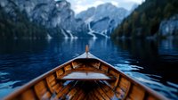Wooden boat bow on tranquil alpine lake surrounded by snow-capped mountains and forest, dramatic perspective view creating peaceful outdoor adventure scene.