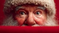 Cheerful elderly Caucasian man with white beard and winter hat peeking over red surface with surprised joyful expression for holiday greeting cards.